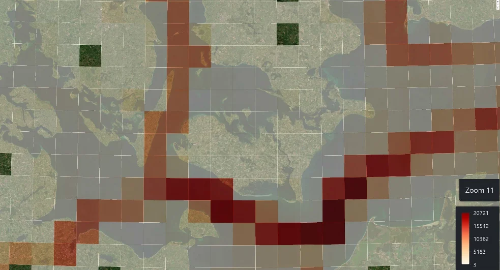 Seagull quad grid at zoom level 11 over a Danish strait, colored by vessel count, with heavy traffic lanes in red