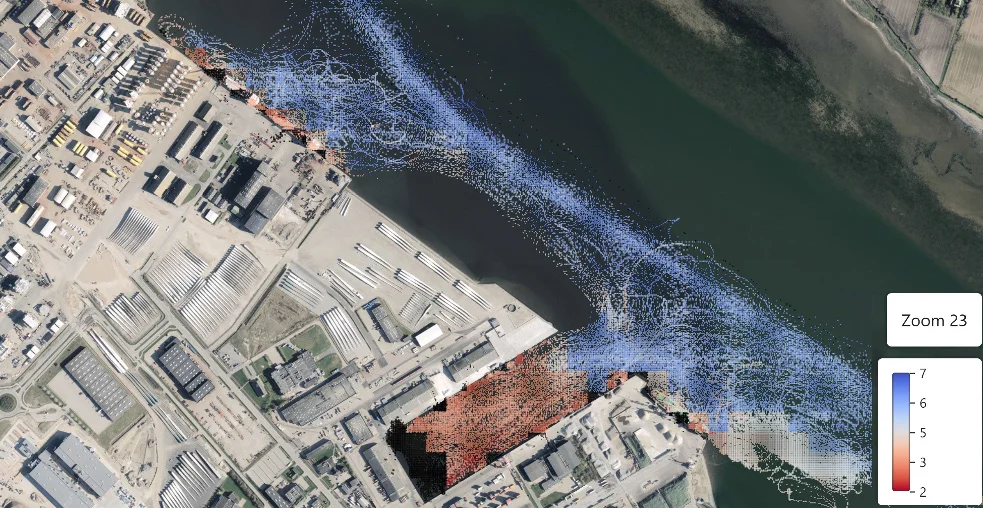 Seagull quad grid at zoom level 23 over a harbor basin on aerial imagery, colored by under keel clearance, with shallow berths in red and the deeper channel in blue